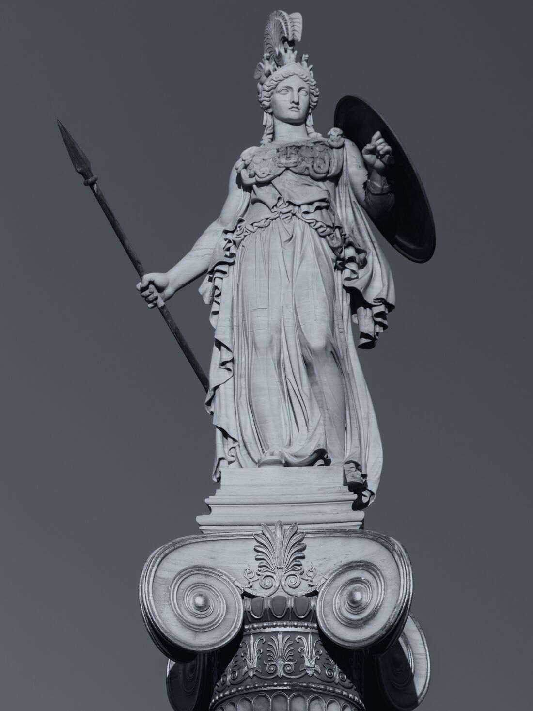 Statue of Athena with spear and shield atop an Ionic column.