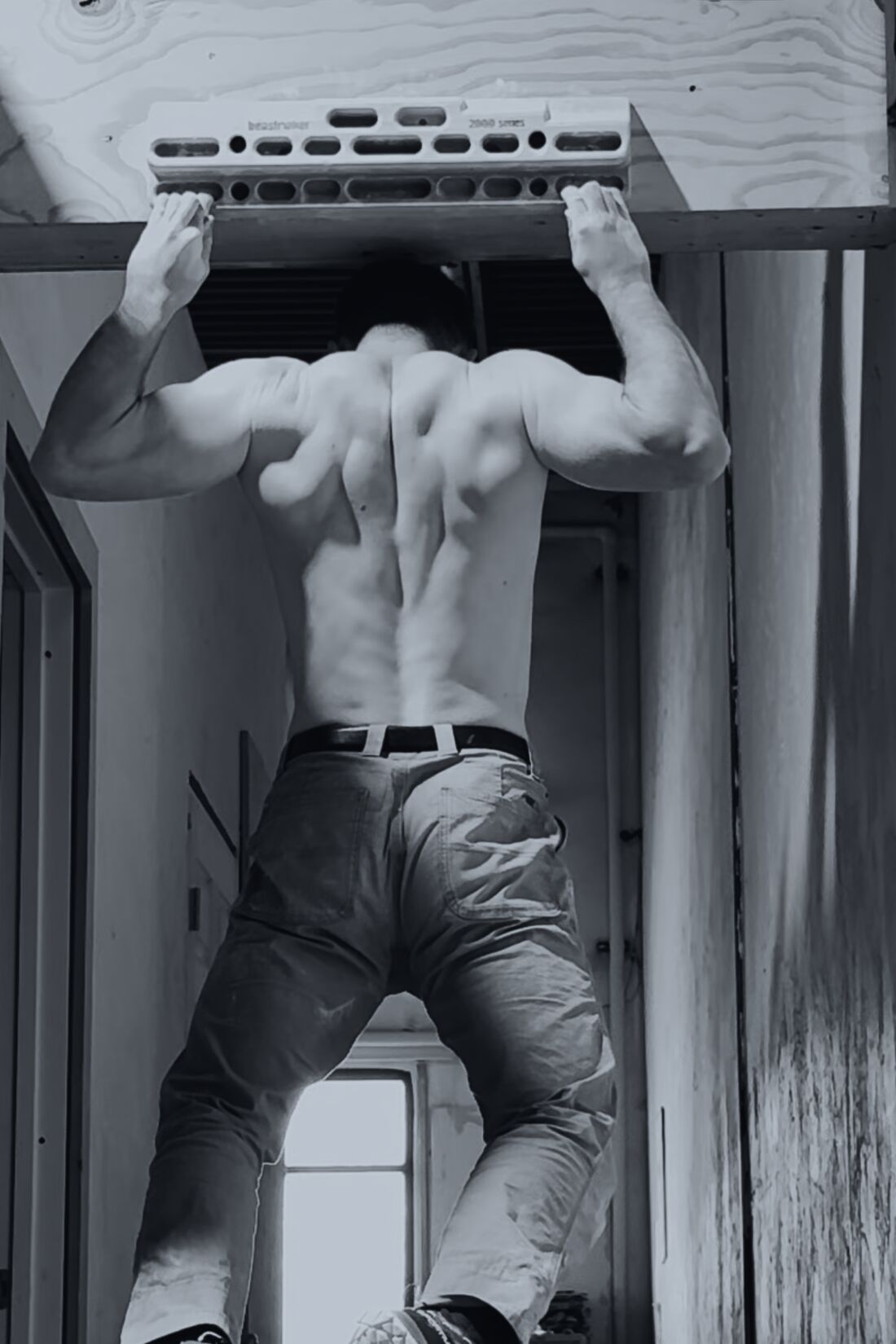 Pull-ups from a beam fixed in a doorway.